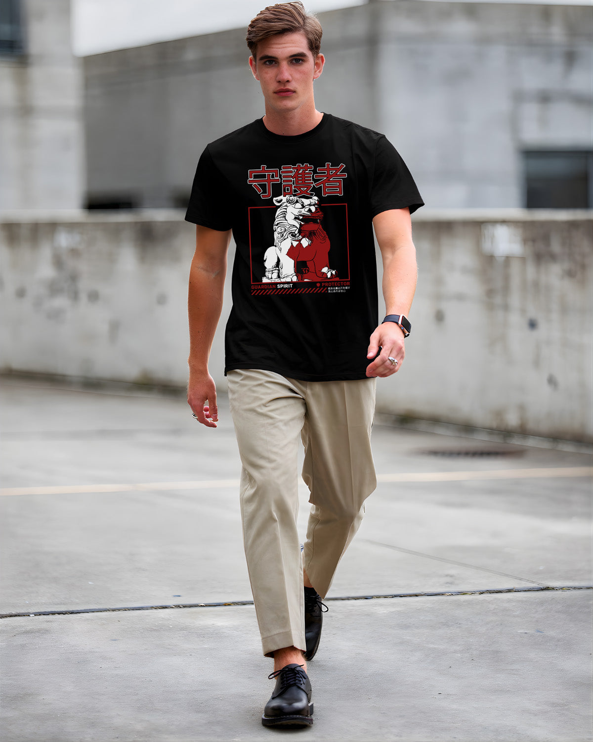 Man wearing a black t-shirt with graphic design and text, walking on a concrete surface.