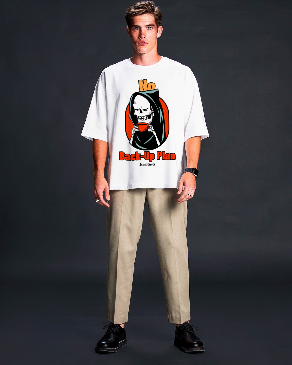 Person wearing a white t-shirt with a graphic design on a dark background