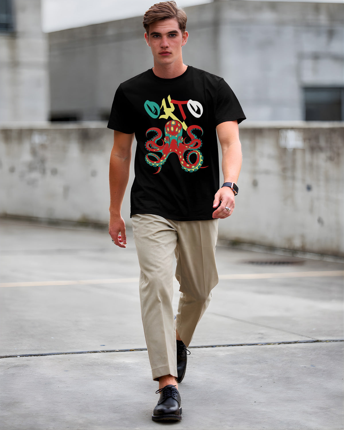 Man wearing a black t-shirt with a colorful octopus design, walking on a concrete surface.
