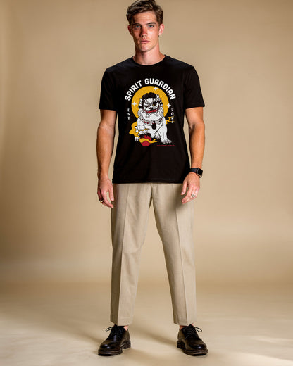 Man wearing a black t-shirt with a graphic design on a beige background